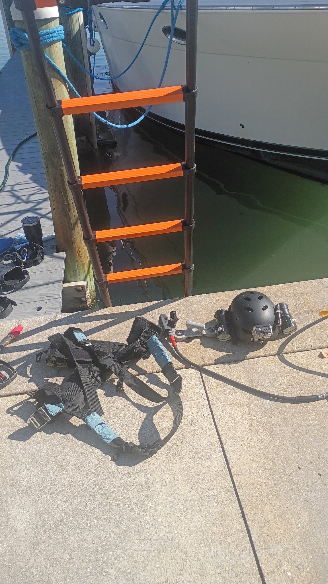 Orange and black dive support equipment staged at an outdoor work site